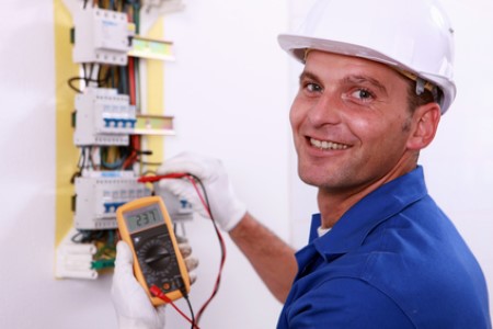Electrician testing fuses